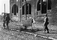 OCT 1944, THE BRAVE SOLDIERS OF THE 26TH INFANTRY WAS FIGHTING THROUGH THE CITY OF AACHEN. THE ATTACHED PHOTO SCENE WAS TAKEN IN THE NORTHERN PART OF THE CITY. THE SOLDIERS BELONGED TO LT. COL